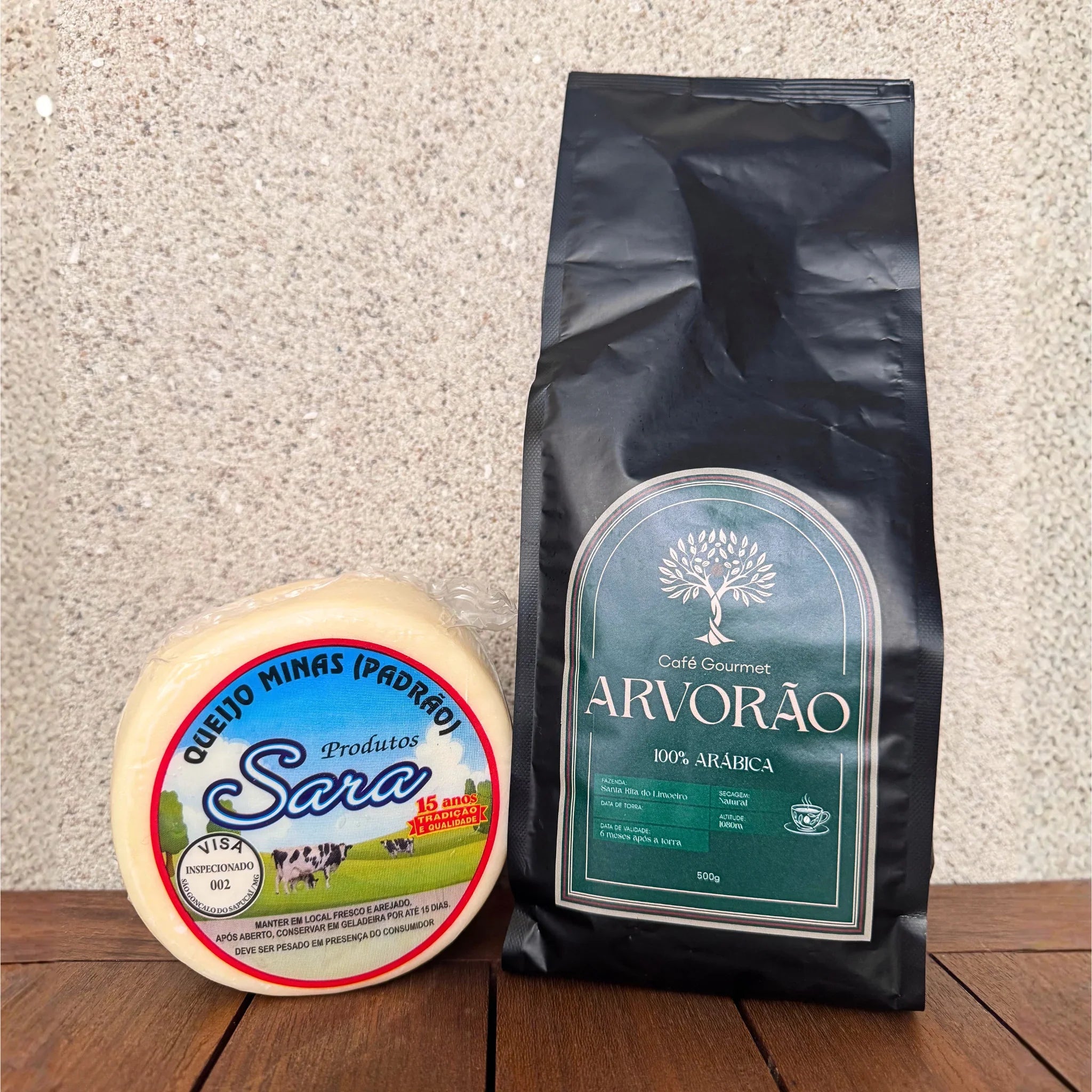 A wheel of Sara brand Minas cheese next to a black bag of Arvorão gourmet coffee.