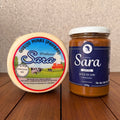 Artisan Queijo Minas cheese and a jar of Doce de Leite from Produtos Sara on a wooden surface.
